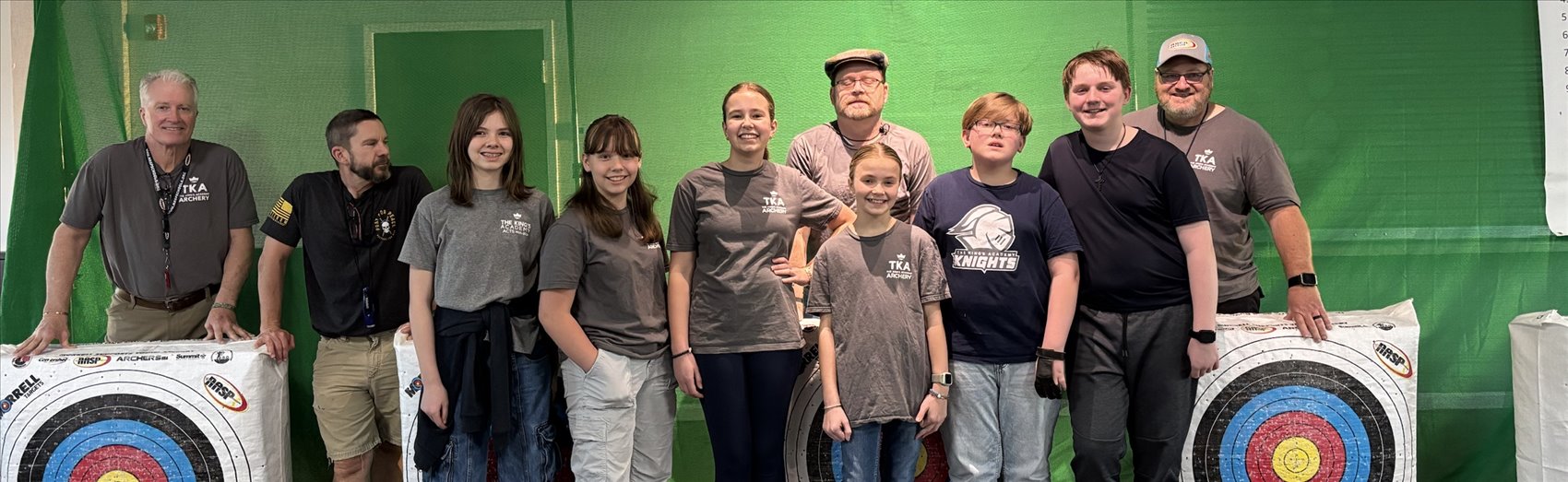 Students and coaches at the Thursday night archery club