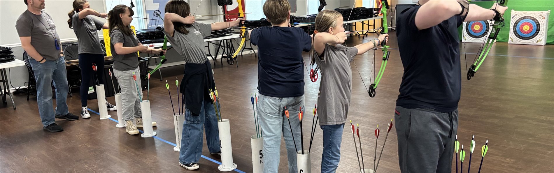 Students shooting on the line at a Rem-Net archery club night